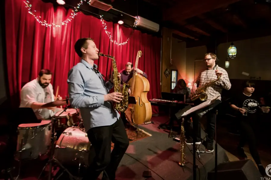 A jazz quartet playing on a small stage at a Lowertown bar